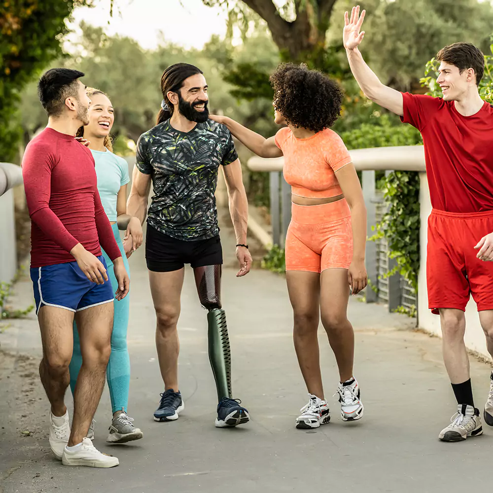 Multicultural group of friends, one man disabled with amputated leg